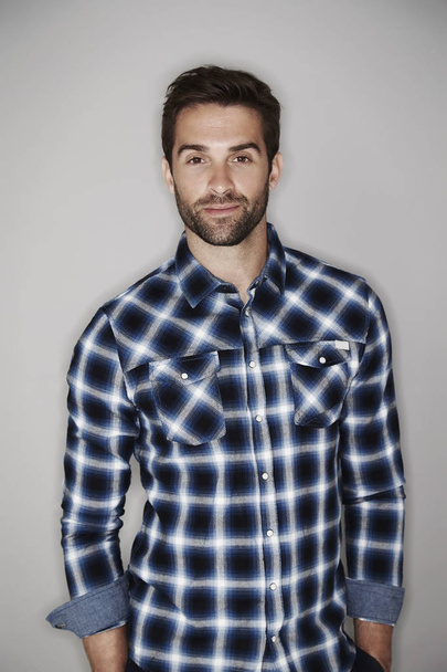 Smiling man in checkered shirt - Foto, afbeelding