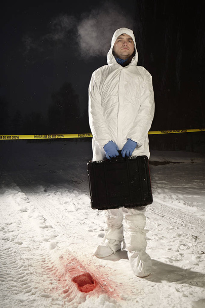 Criminologist leaving location after praparing shoe print for casting - Фото, изображение