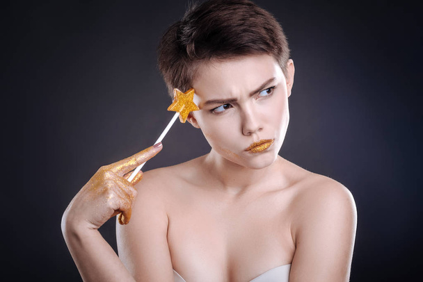 Thouhtful woman posing with lollipop - Photo, Image