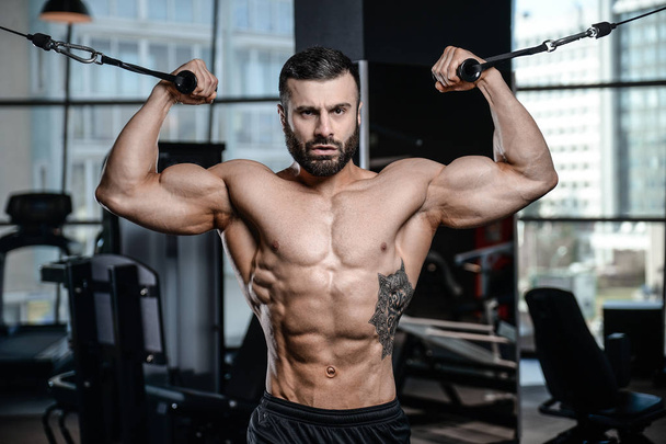 Fitness instructor handsome man in the gym gain muscle  - Fotoğraf, Görsel