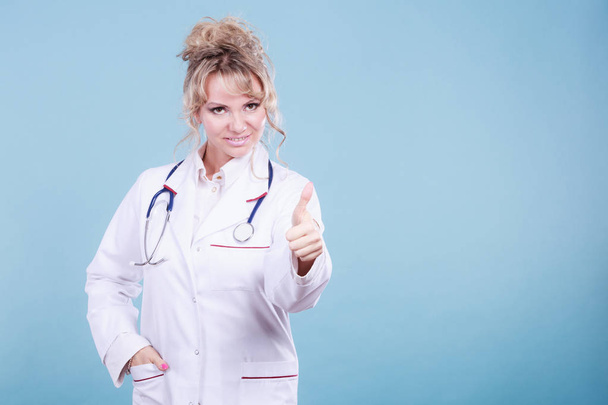 Female doctor showing thumb up. - Фото, изображение