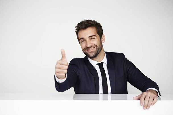 Smiling businessman with thumb up  - Foto, Imagen
