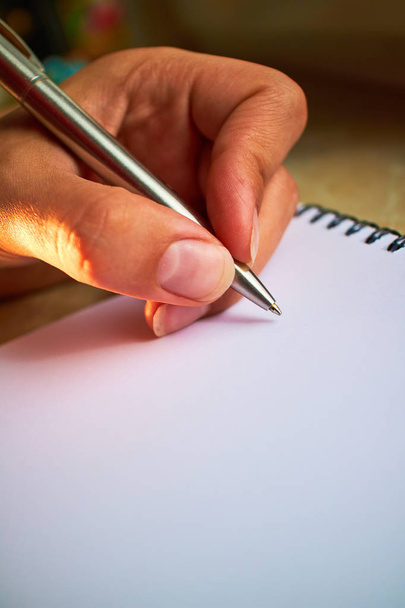 write with a pen in a notebook  - Foto, Bild
