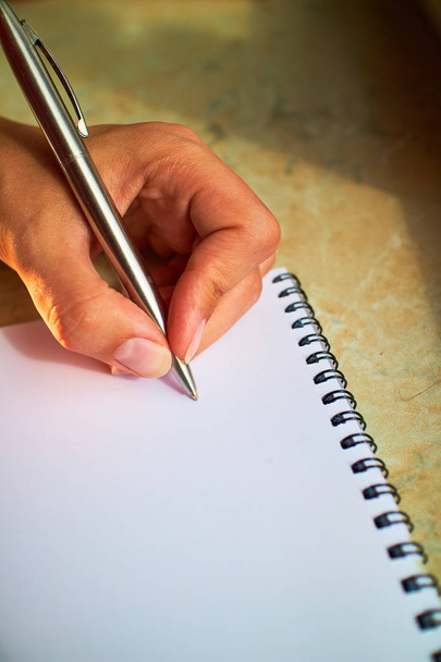 write with a pen in a notebook  - Fotó, kép
