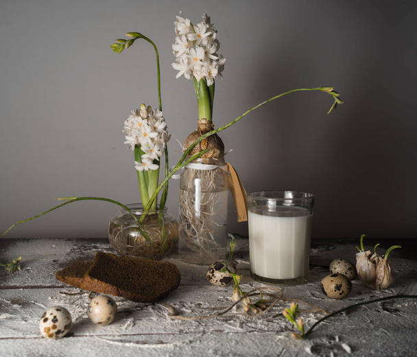 Still life with milk, bread, eggs and hyacinths in glass vases. - Φωτογραφία, εικόνα