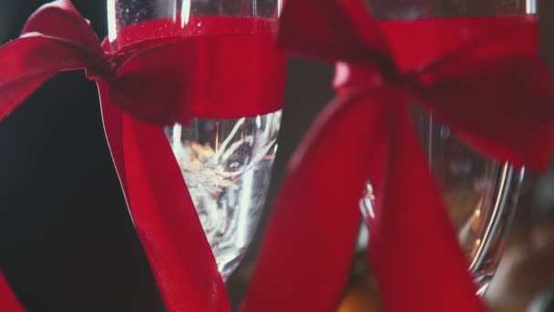 Two glasses of champagne with red ribbon. The 14th of February. - Filmmaterial, Video