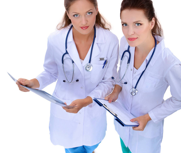 Portrait of two successful female doctors holding a writing pad and x-ray - Foto, afbeelding