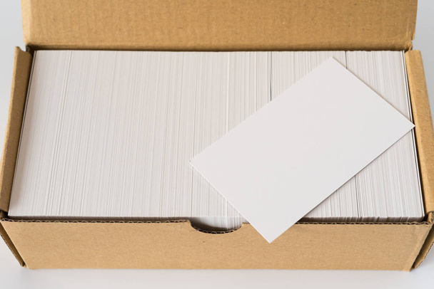 top view box of business cards with a blank one good for text and logo stands on top on white - Фото, изображение