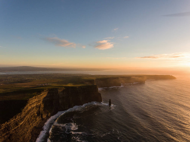 Aerial Ireland countryside tourist attraction in County Clare. The Cliffs of Moher sunset and castle Ireland. Epic Irish Landscape along the wild atlantic way. Beautiful scenic irish nature - Фото, изображение