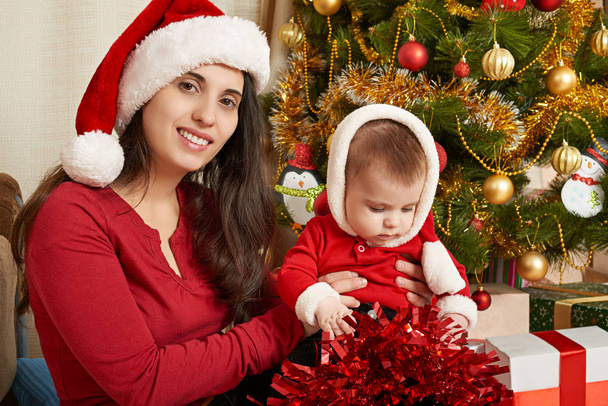 happy family portrait in christmas decoration, winter holiday concept, decorated fir tree and gifts - Foto, Imagen