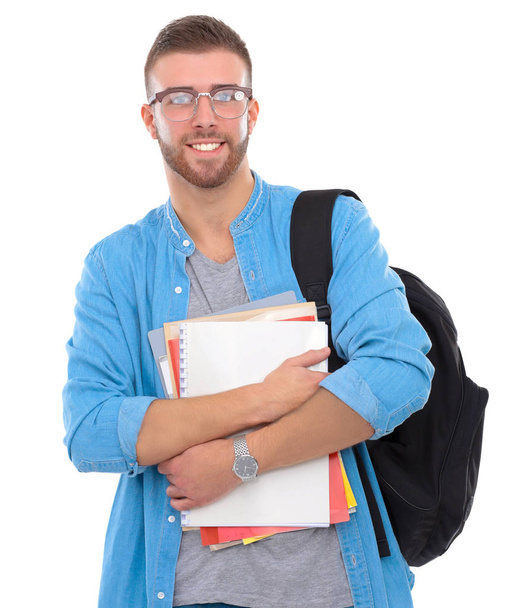 Male student with a school bag holding books isolated on white background - Photo, image