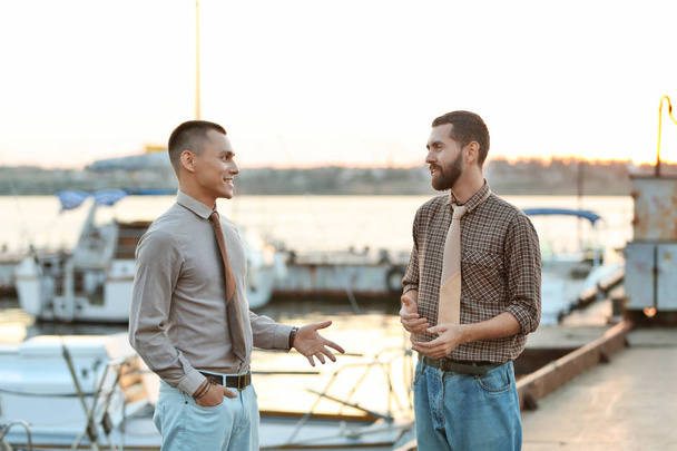Men in leather ties standing on a pier - Photo, Image