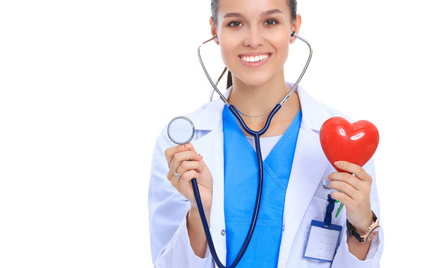 Doctor with stethoscope examining red heart, isolated on white background - Photo, image