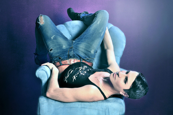 Young rich man on a sofa - Foto, Imagen