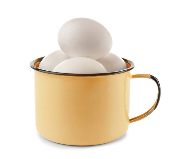 Raw eggs in enamel mug - Fotó, kép
