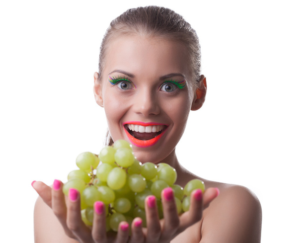 Funny young woman offer green grapes isolated - Photo, Image