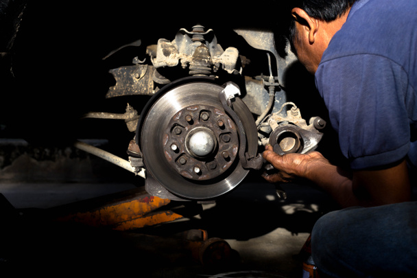 Mechanic repairing car brake disk  - Photo, Image