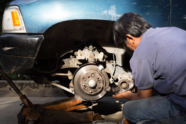 Mechanic repairing car brake disk  - Photo, Image
