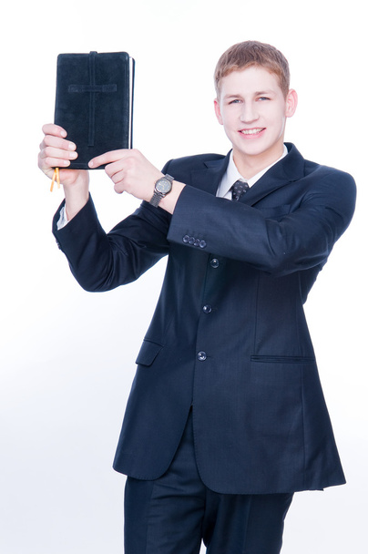 Cheerful man showing Bible - Fotó, kép
