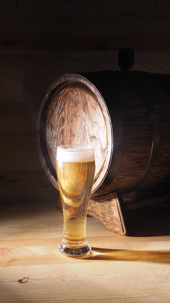 Beer mugs and barrel on a wooden background - Photo, image