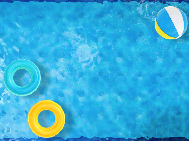 boules de plage et anneaux de natation flottant sur la piscine
  - Photo, image