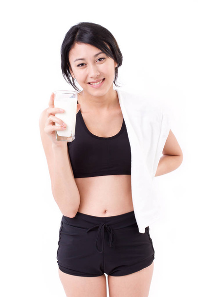beautiful sport woman holding a glass of milk - Fotoğraf, Görsel