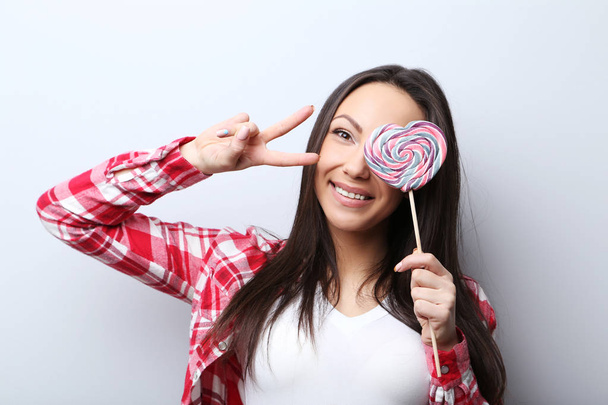 Young woman with lollipop - Foto, Imagen