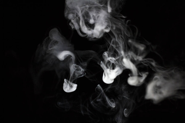 Smoke slaves on a black background - Foto, Imagen