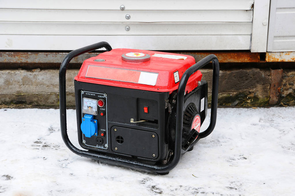 Portable electric generator. Generator running in the cold winter. - Photo, Image