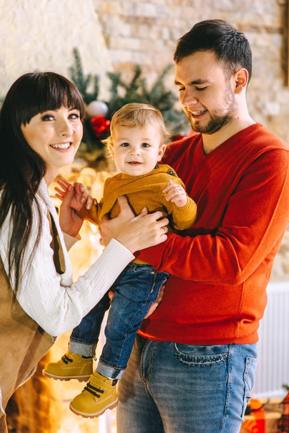 Young family in Christmas interior - 写真・画像