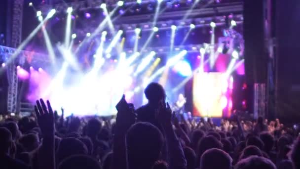 Shadows of excited audience jumping at concert with hands raised in air, slow-mo - Footage, Video