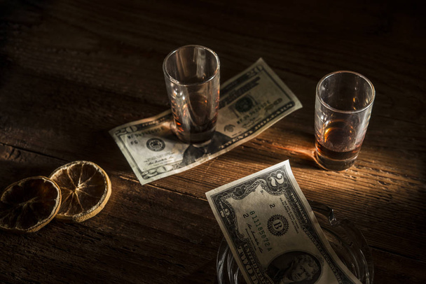 Dollars and glasses on wooden table - Fotografie, Obrázek