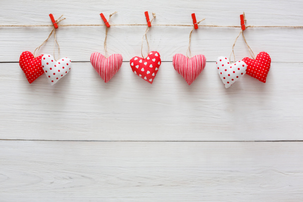 Valentine day background, pillow hearts border on wood, copy space - Photo, Image