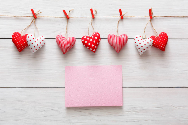 Single pink string heart isolated on light pastel pink background. Copy  space. Valentines day card. Flat lay. Stock Photo