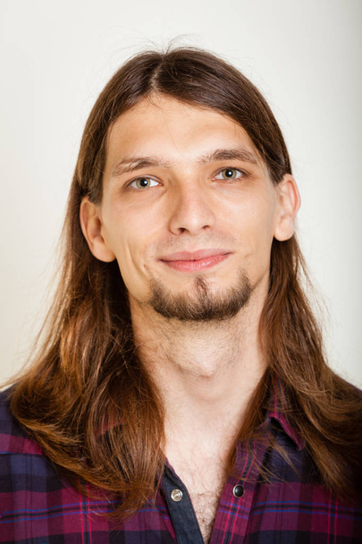 Smiling guy with long hairs. - Фото, зображення