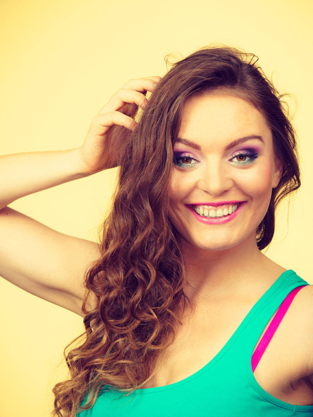 Portrait, young woman wearing colorful makeup and blue top - Foto, immagini