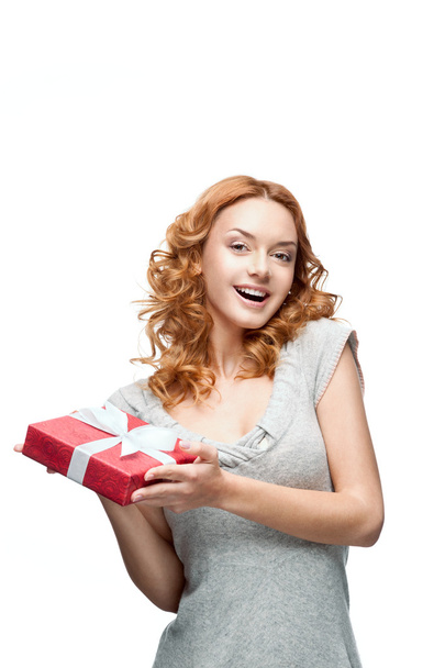 Young red-haired happy smiling girl holding gift - Foto, Imagen