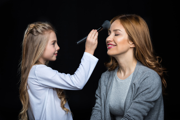 Girl doing makeup to her mother - Photo, Image
