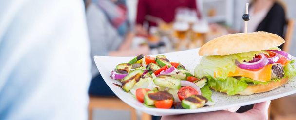 Burger and salad on a plate - 写真・画像