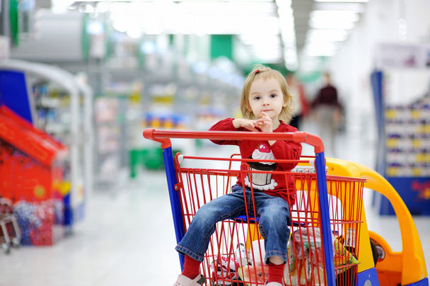 Adorable toddler sitting in shopping cart - Fotografie, Obrázek
