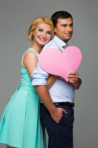 Beautiful couple holding pink heart - Photo, Image
