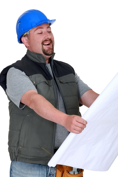 Builder laughing at plans - Zdjęcie, obraz