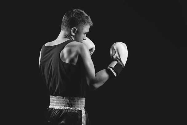 Young boxer sportsman on black background - Photo, Image