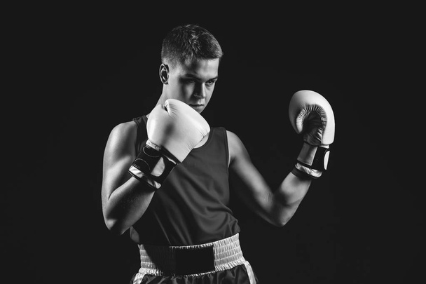 Young boxer sportsman on black background - Photo, Image