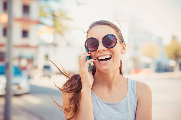 Happy smiling laughing girl talking on phone - Фото, изображение