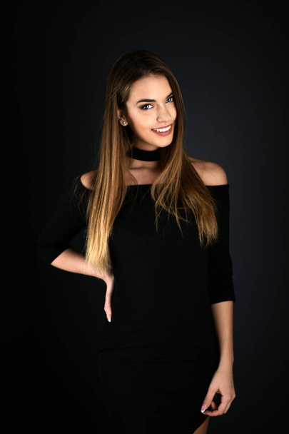Beautiful sexy white woman in black dress posing at studio - Foto, Imagem
