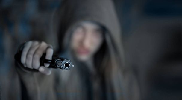 Teenager Girl Aiming a gun at the camera, blurred focus - Foto, Imagem