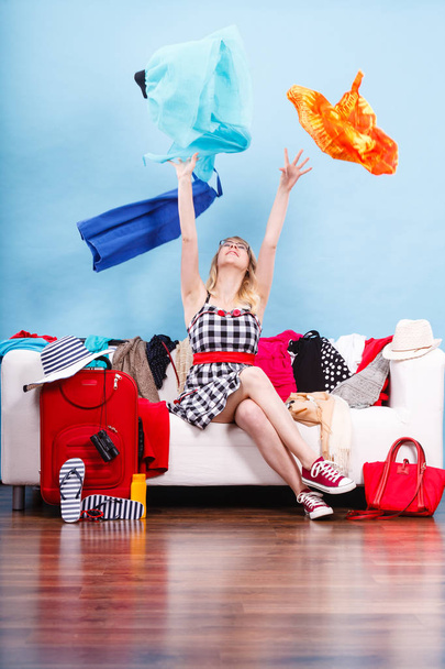 Woman throwing up clothes, clothing flying everywhere - Foto, afbeelding