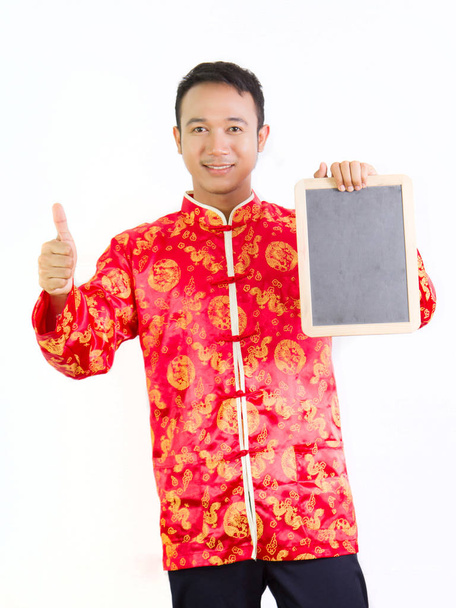 Chinese man in traditional Chinese Tang suit holding the blank b - Photo, Image