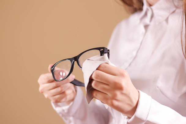 Women hand cleaning glasses lens with isolated background - Фото, зображення